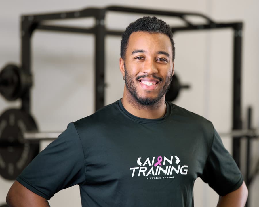Marcus McDuffie standing in front of a squat rack in the studio.